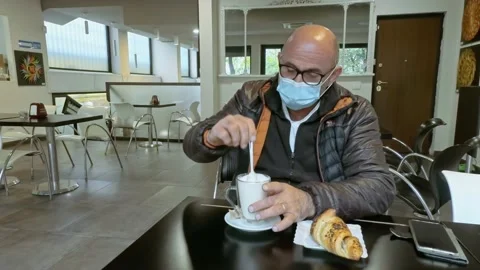 Man at Bar Mixes Milk While Wears a Medical Mask During Covid-19 Pandemic Stock Footage 141385339