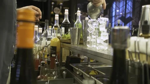 Man at the bar preparing a cocktail with ice Stock Footage 247028840