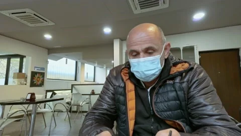 Man at Bar with Smartphone While Wears Medical Mask During Covid-19 Pandemic Stock Footage 141385865