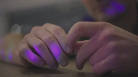 Man in a bar takes off wedding ring, spins it in his hands. Puts in back on. Stock Footage 148677870
