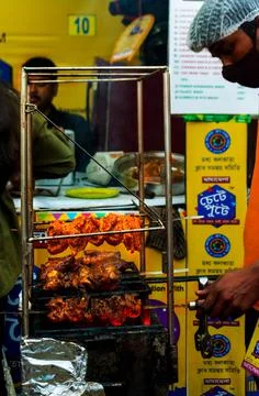 A man barbecuing chicken. Stock Photos
