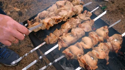 Man barbecuing on the grill, close-up. Barbecue outdoors Stock Footage 126955762