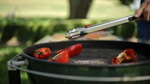 Man barbecuing red bell peppers. 스톡 동영상 88368612