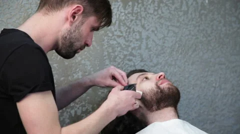 Man barber shaving client's beard Stock Footage 62980326