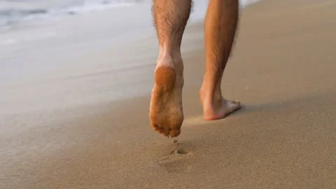 man bare feet walking at a sand beach | Stock Video | Pond5