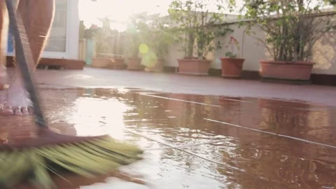 Man barefoot washes a tile patio 動画素材 147173763
