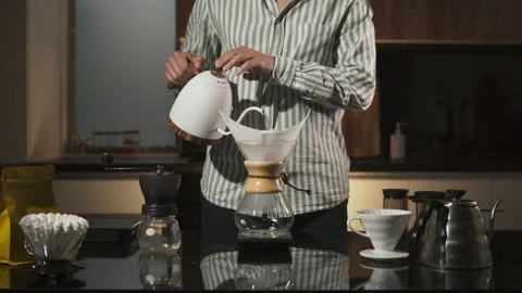 Man Barista making filter coffee on bar counter, alternative brewing, colombian Stock Footage 140609489
