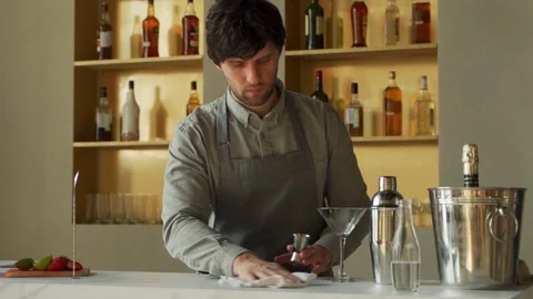 Man bartender standing at bar counter wiping table cheerful. Bartender in the 스톡 동영상 153458505