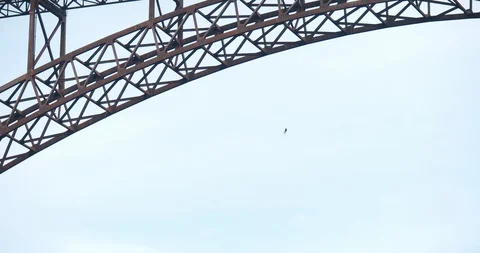 Man Base Jumping Off Bridge With Parachute 스톡 동영상 127466440