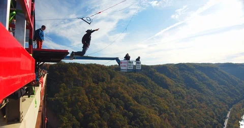 Man Base Jumping Off Bridge With Parachute, Slow Motion Backflip Stock Footage 127466572