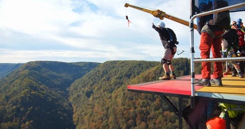 A Man Base Jumping Off Bridge With Parachute, Slow Motion Jump Stock Footage 127466875