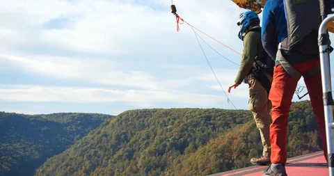 A Man Base Jumping Off Bridge With Parachute, Slow Motion Jump Stock Footage 127466922