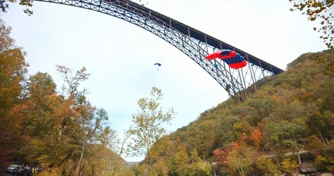 Man Base Jumping With Parachute, Slow Motion, Forest Landscape Video stock 127467903