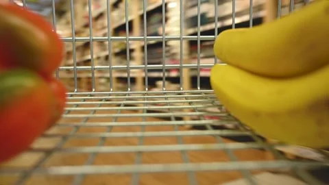 Man with basket walks quickly through supermarket Stock Footage 141916885