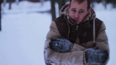 Man basks in the winter against snow Stock Footage 70678684