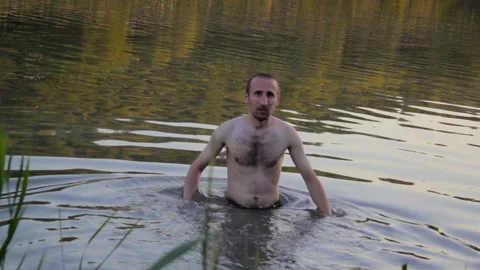 Man bathes in the lake Stock Footage 136880405