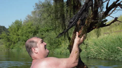 Man Bathes in the River With a Tree Stock Footage 65212994