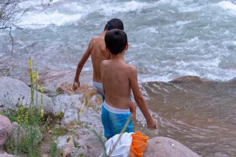 A man is bathing on a mountain river Stock Photos
