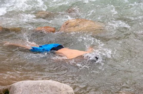 A man is bathing on a mountain river Stock Photos
