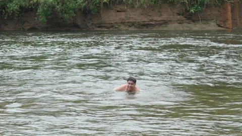 Man bathing in river in Ecuador Stock Footage 312149642