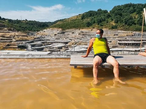 Man bathing in saline watersman bathing in saline waters, enjoying a moment of Stock Photos