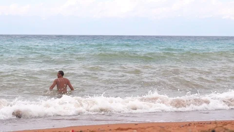 Man bathing in the sea Stock Footage 95165246