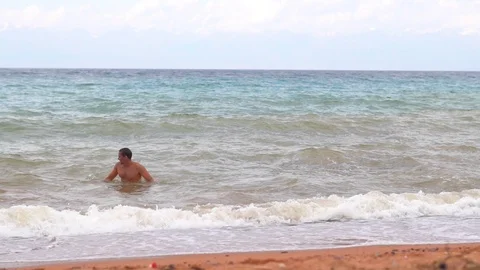 Man bathing in the sea Stock Footage 95166072