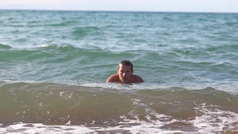 Man bathing in the sea Stock Footage 103255707