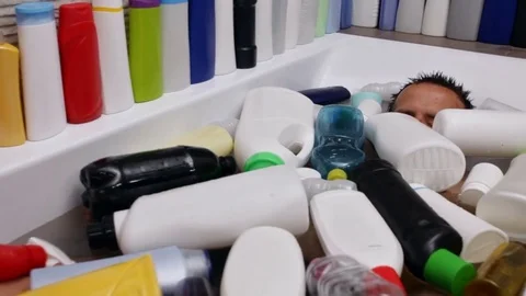 Man bathing in water covered in plastic recipients Видео 82781384
