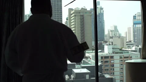 Man in bathrobe walking in his flat and throwing dollars Stock Footage 88167854
