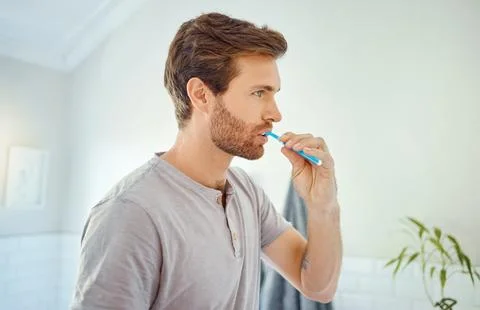 Man, bathroom and brushing teeth for dental hygiene, health and oral wellness Stock Photos