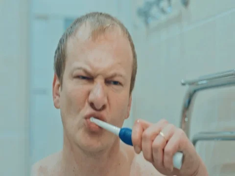 The man in the bathroom brushing her teeth. Slow motion Stock Footage 74145973