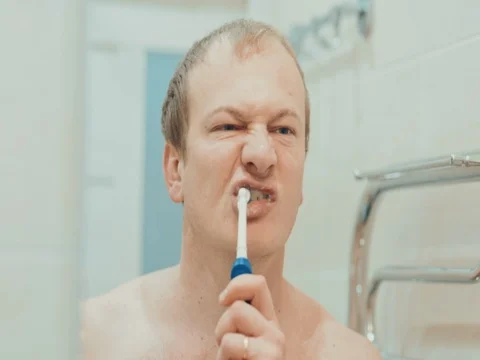 The man in the bathroom brushing her teeth. Slow motion Stock Footage 74145995