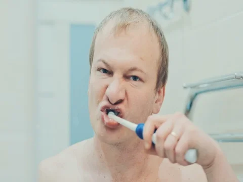 The man in the bathroom brushing her teeth. Slow motion Stock Footage 74146127