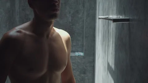 Man in bathroom reaches for towel completing his personal grooming routine Stock Footage 312503653