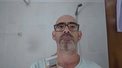 Man in bathroom shaving his beard Stock Footage 288092924