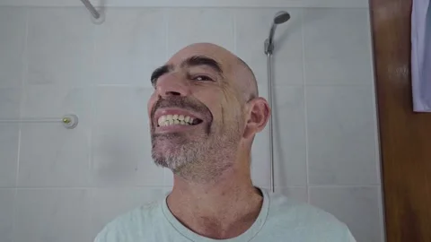 Man in bathroom shaving his beard Stock Footage 288093355