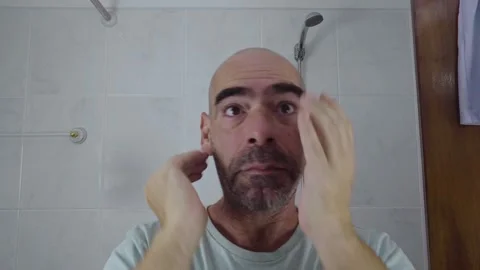 Man in bathroom shaving his beard Stock Footage 288093582
