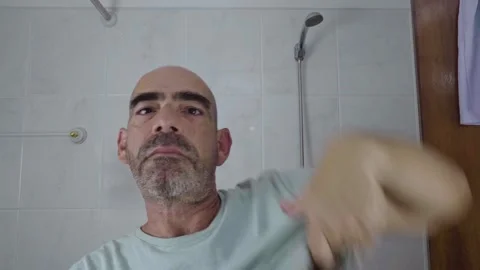 Man in bathroom shaving his beard Stock Footage 288093631
