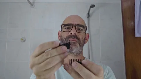 Man in bathroom shaving his beard Stock Footage 288094154
