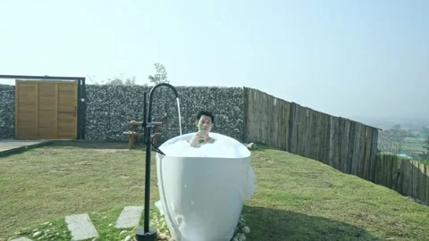 A man is in a bathtub with bubbles Stock Footage 313942754