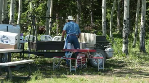 Man at BBQ grill in mountain forest P HD 0295 Stock Footage 11194361