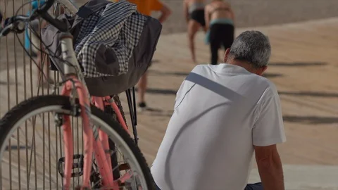 A man is on the beach with a bicycle 動画素材 122135416