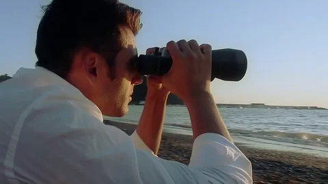 The man on the beach with binoculars Stock Footage 81017594