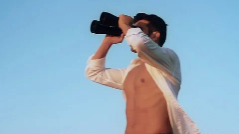 The man on the beach with binoculars Stock Footage 81056497