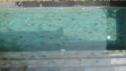 A man in beach clothes jump into the pool. Slow motion. Stock Footage 103423624