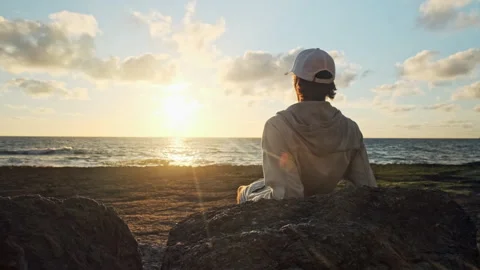 Man on a beach is looking distance during beautiful summer sunset. Human lo.. Stock Footage 254655055