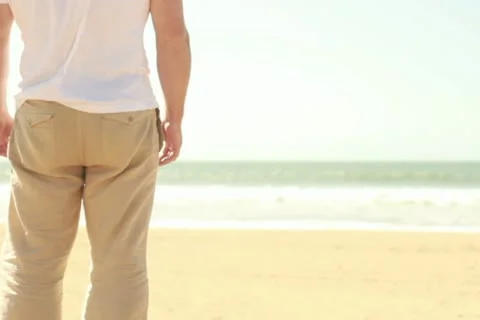 Man on beach looking at the sea 스톡 동영상 10851391