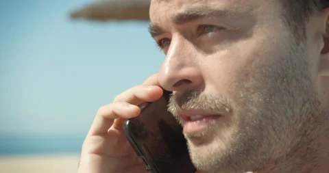 Man at beach makes phone call Video stock 205026822