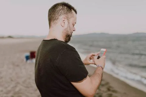 Man on the beach making a call Stock Photos
